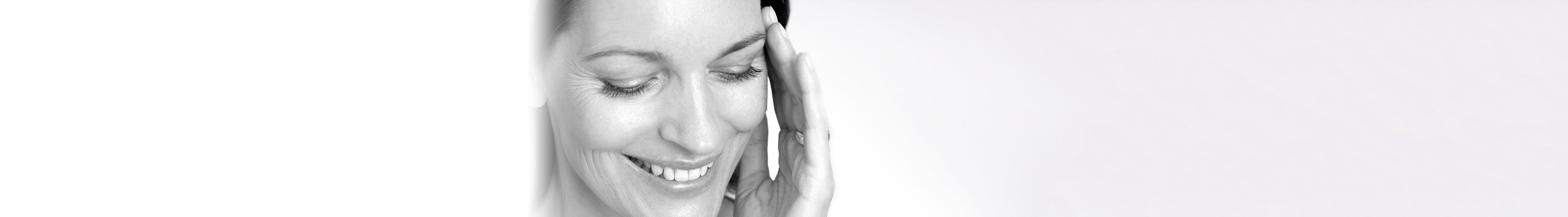 Woman touching her face with her left hand.