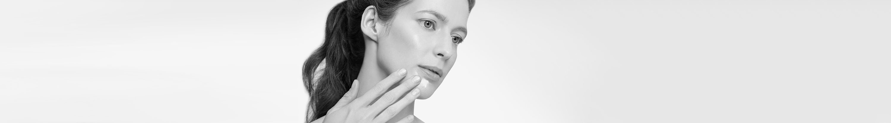 Woman touching her face with hand.