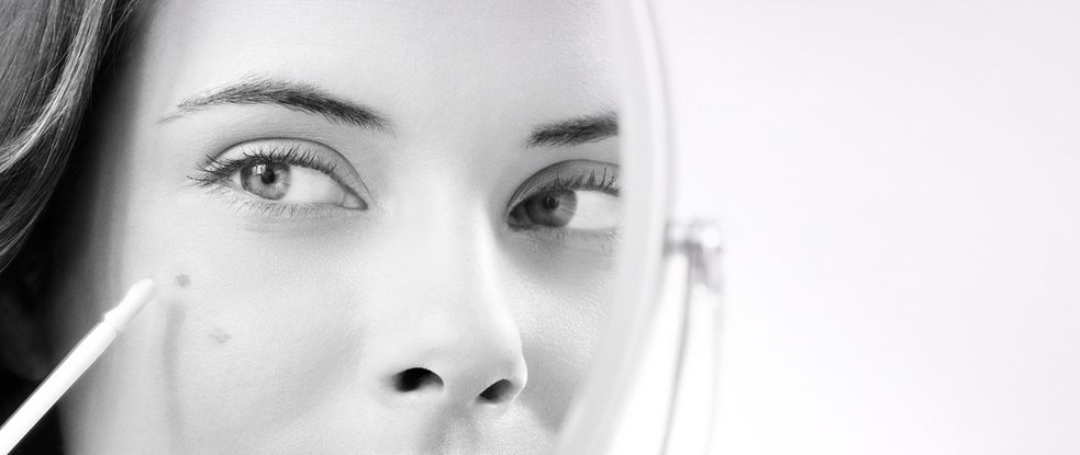 Eucerin model is using spot corrector against dark spots