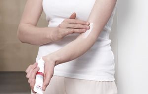 Woman applying Eucerin AtoControl Acute Care Cream on the crook of her arm.