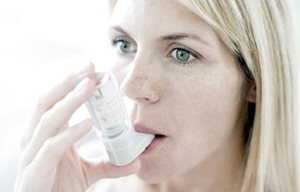 Woman using inhalator.