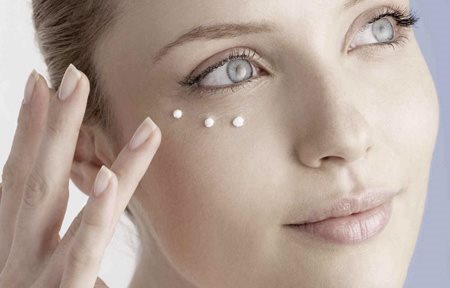 Woman applying Eucerin Hyal-Urea Eye Cream