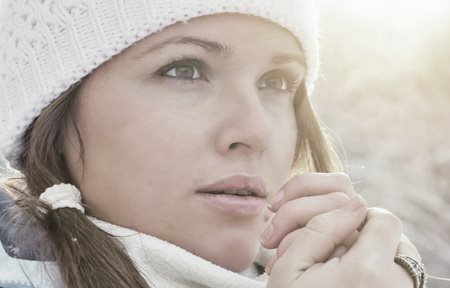 Woman wearing winter clothing to help prevent dry skin