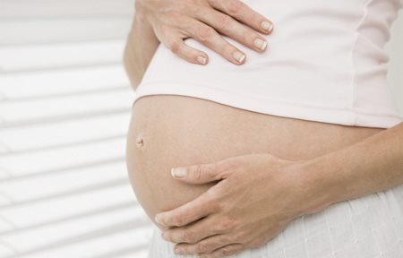 Pregnant woman holding her stomach
